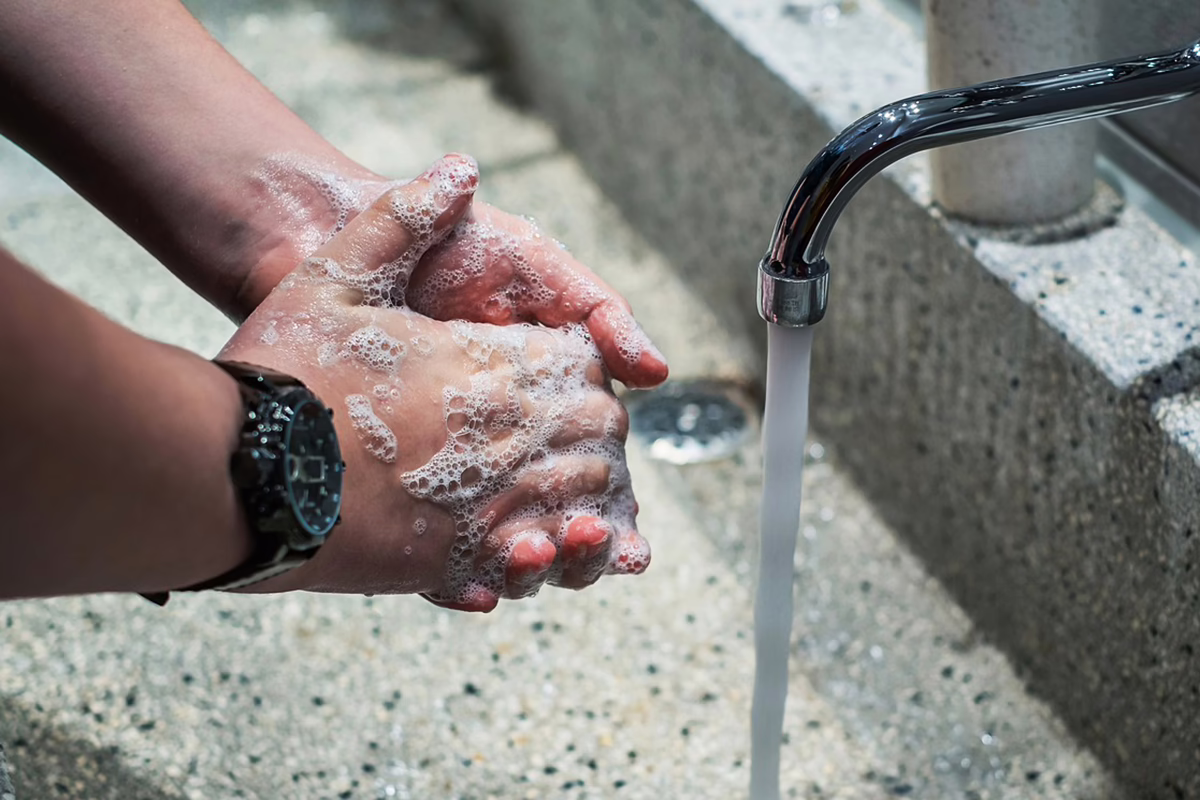 Hand washing at a touchless faucet