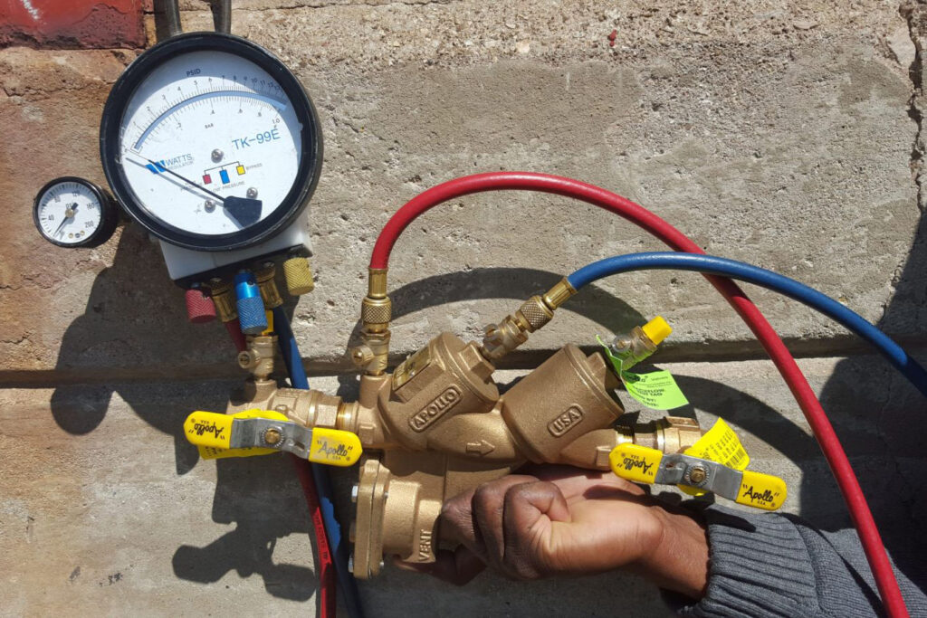 A pressure regulating valve installed outside a home.