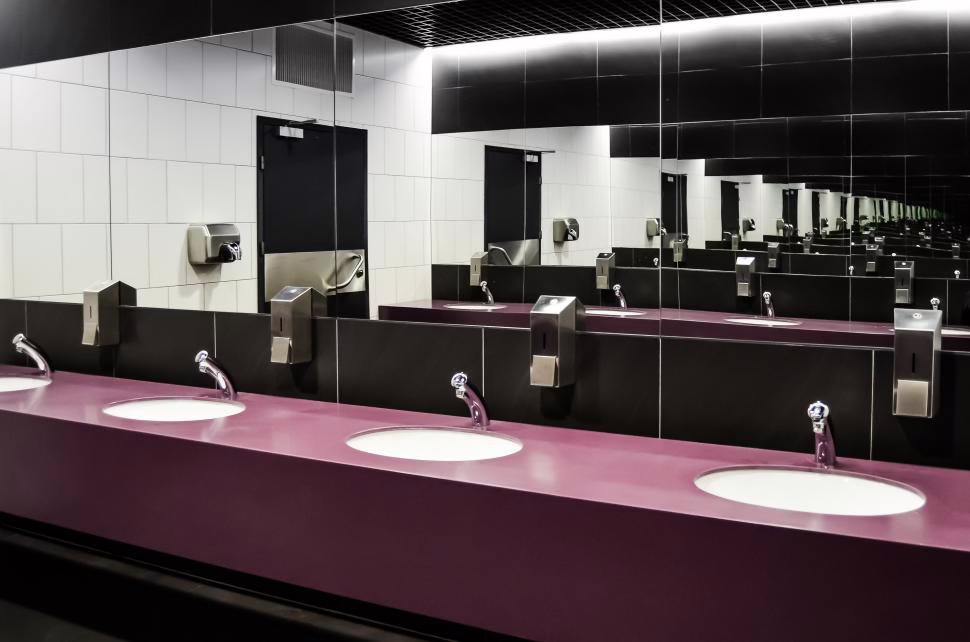 A clean, sanitized public restroom with sinks and mirrors